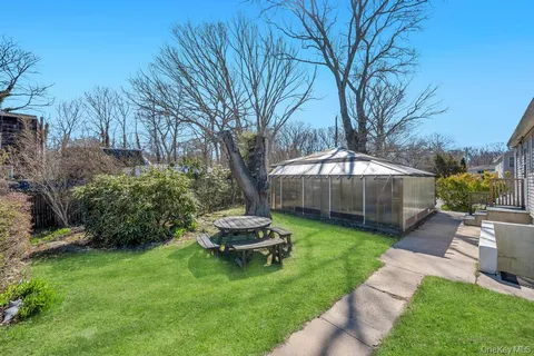 a backyard of a house with table and chairs