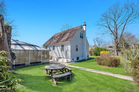 a view of a house with a yard and garage