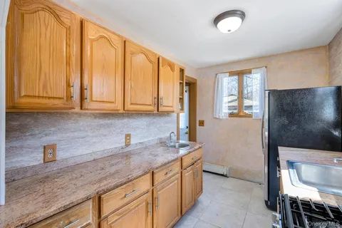 a kitchen with stainless steel appliances granite countertop a sink and a refrigerator