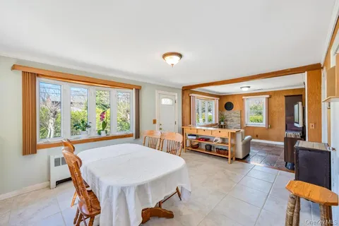 a bedroom with furniture and a large window