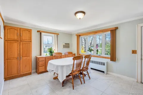 a view of a dining room with furniture window and outside view