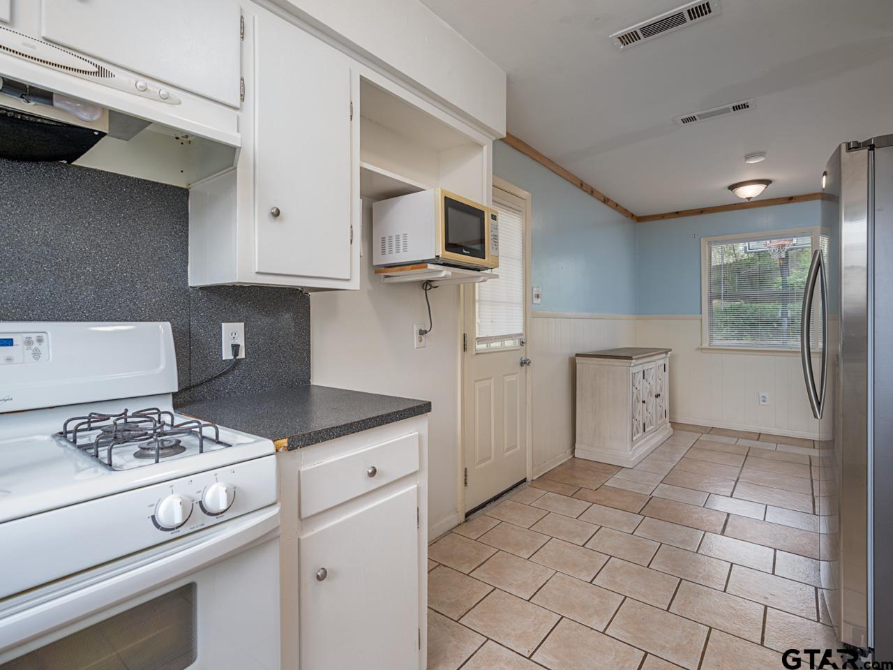2722 McDonald Road Tyler, TX 75701 - Photo 12 of 28 a kitchen with cabinets and appliances