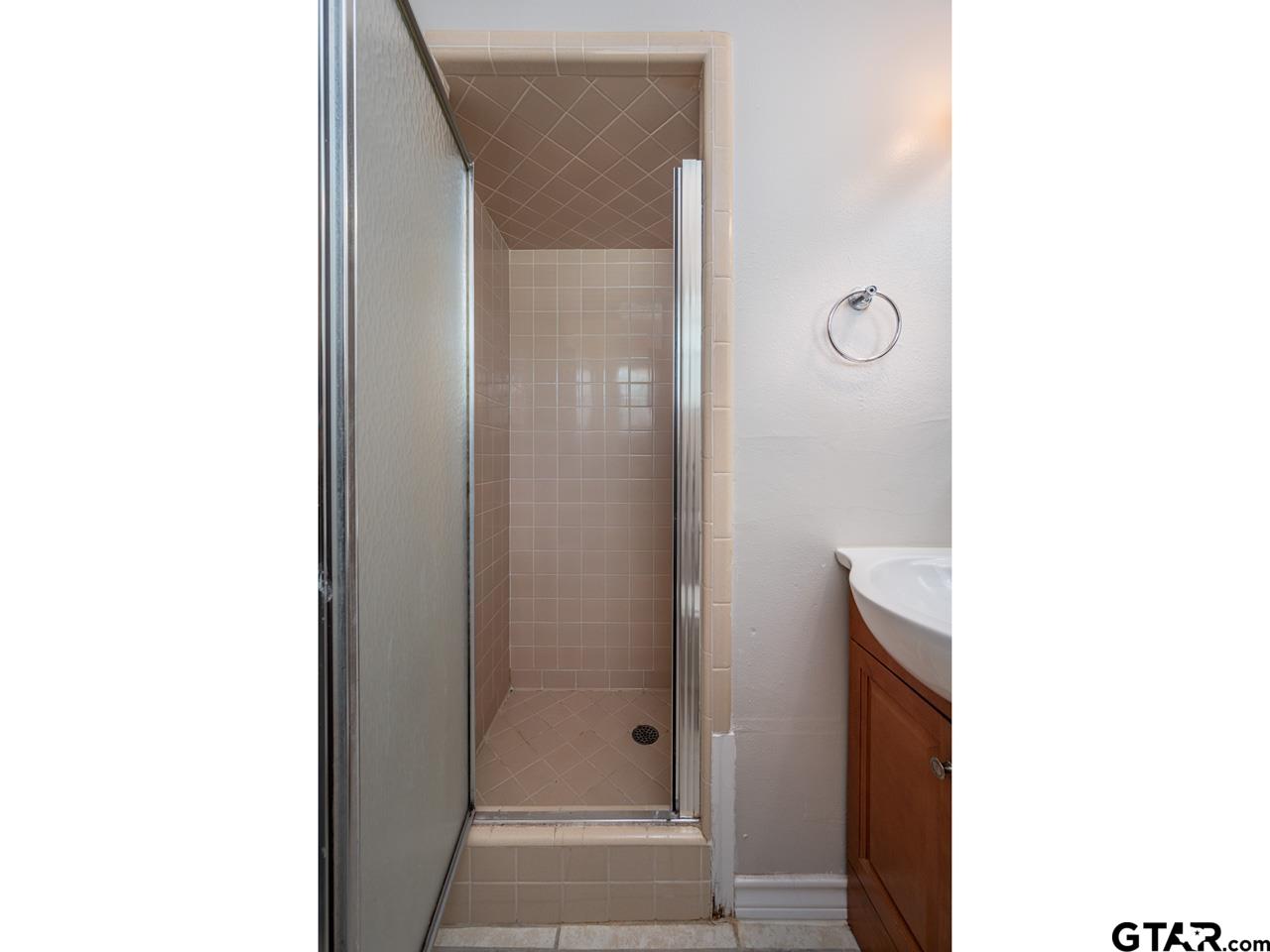 2722 McDonald Road Tyler, TX 75701 - Photo 18 of 28 a bathroom with a glass shower door
