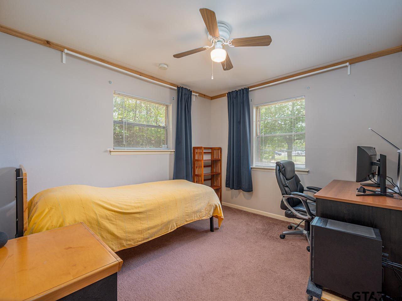 2722 McDonald Road Tyler, TX 75701 - Photo 19 of 28 a bedroom with a bed and a desk