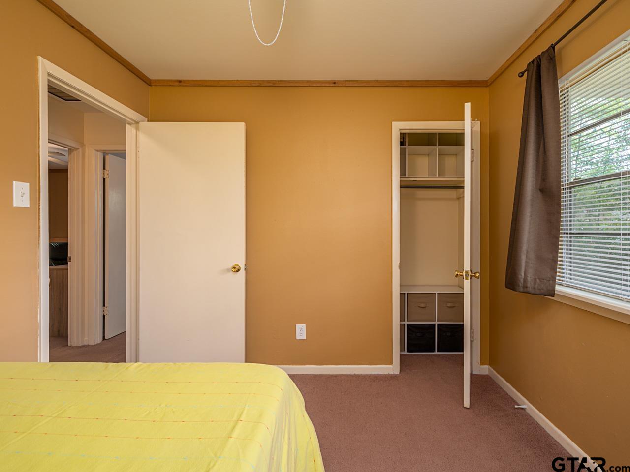 2722 McDonald Road Tyler, TX 75701 - Photo 24 of 28 a bedroom with a bed and a window