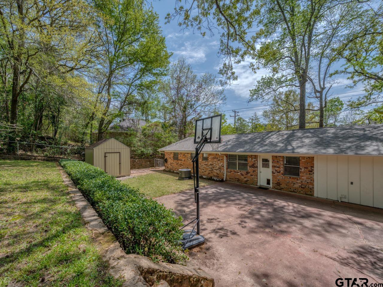 2722 McDonald Road Tyler, TX 75701 - Photo 27 of 28 a view of a house with a yard and large tree