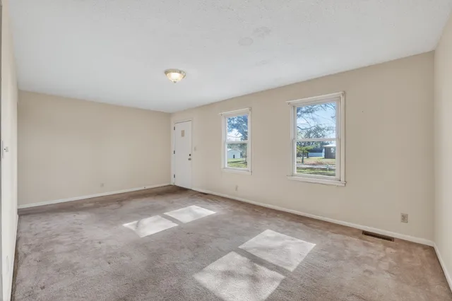 a view of an empty room with a window