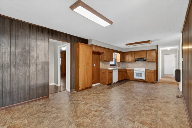 a view of a kitchen with refrigerator and a sink