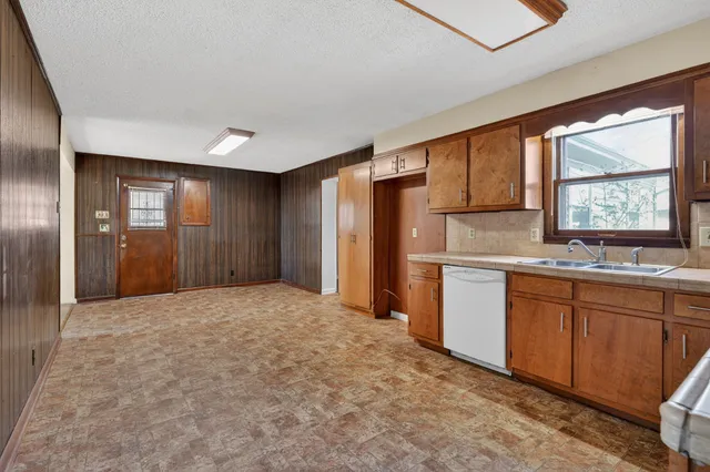 a kitchen with stainless steel appliances granite countertop a refrigerator and sink