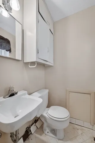 a bathroom with a sink a toilet and mirror