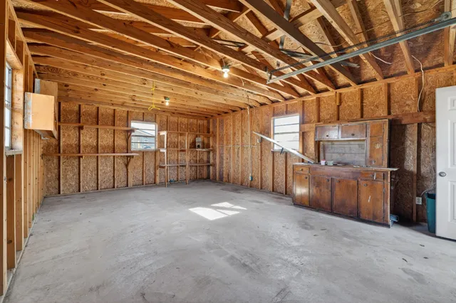 a view of empty room with wooden walls