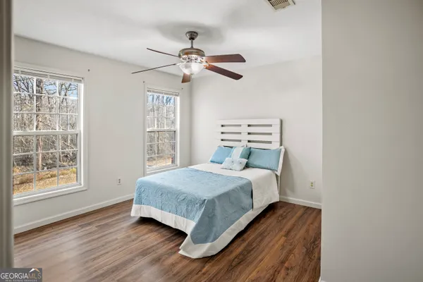 a bedroom with a bed and window