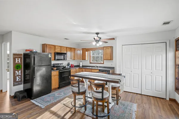 a kitchen with stainless steel appliances granite countertop a refrigerator and a stove top oven
