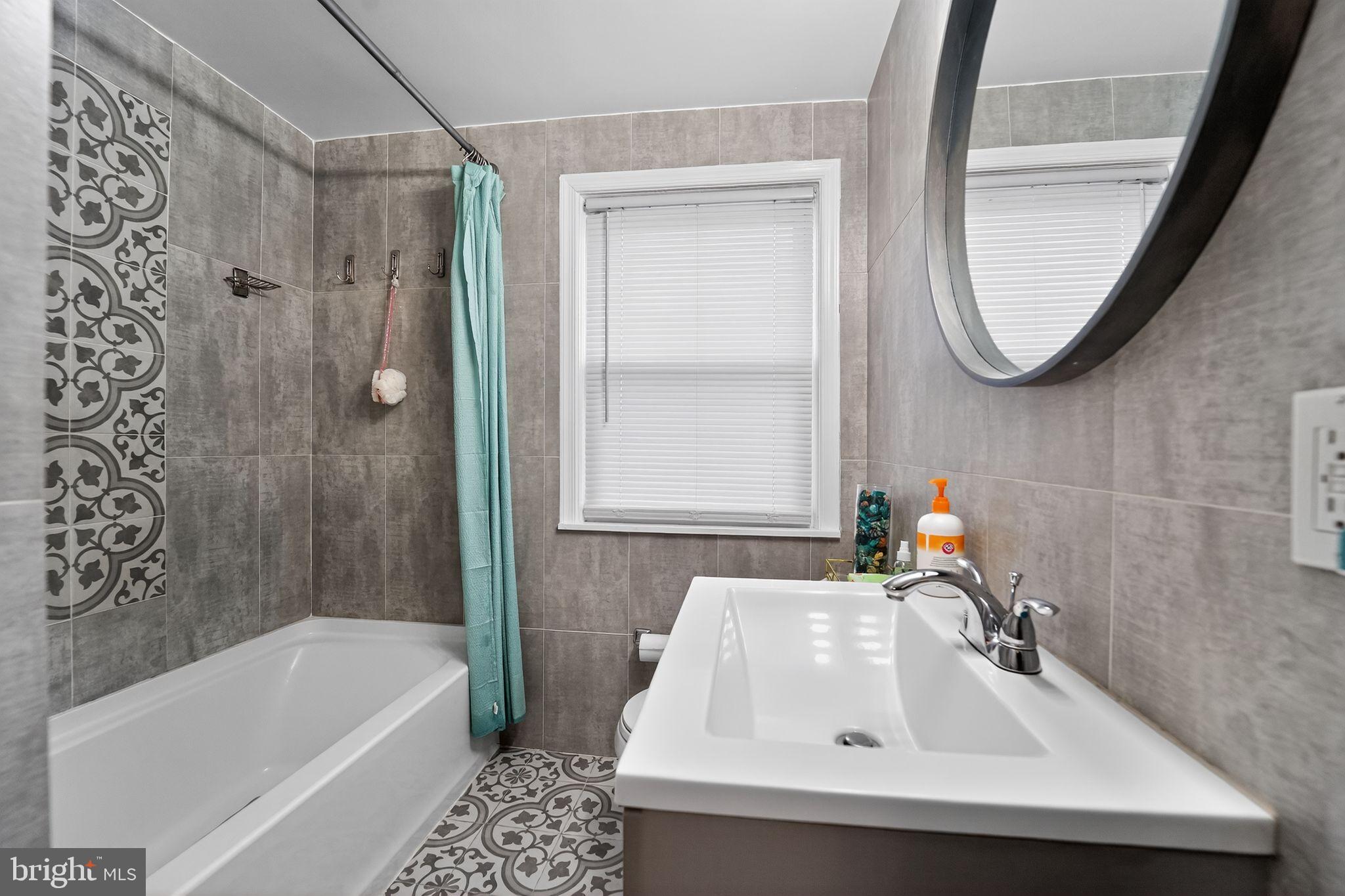 1371 East Northern Parkway Baltimore, MD 21239 - Photo 13 of 29 Modern bathroom with stylish tile accents.