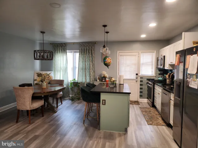a kitchen with sink cabinets and wooden floor
