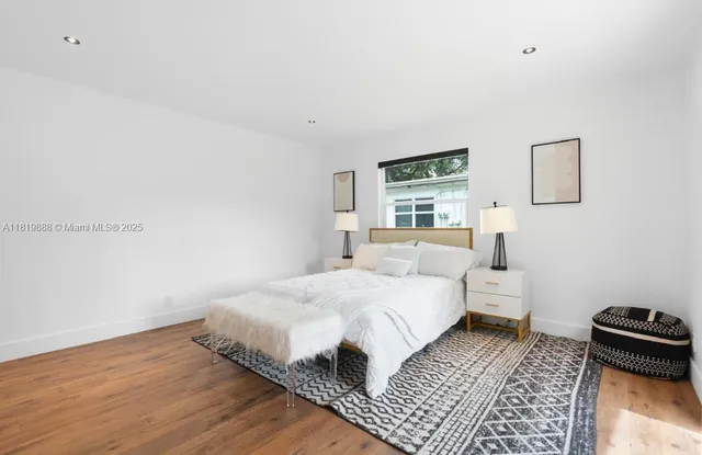 a bedroom with a bed and a couch