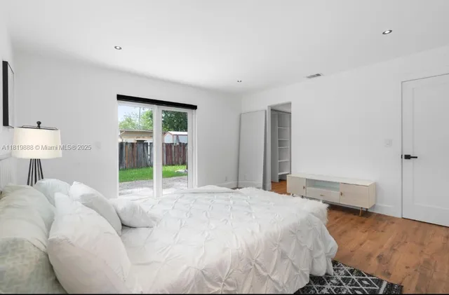 a bed room with a bed and a lamp