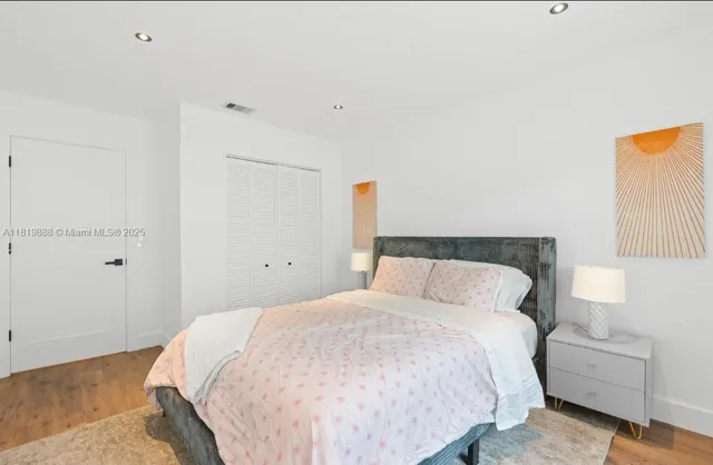 a bedroom with a bed and a night stand