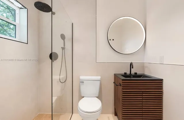 a bathroom with a toilet a sink and a mirror