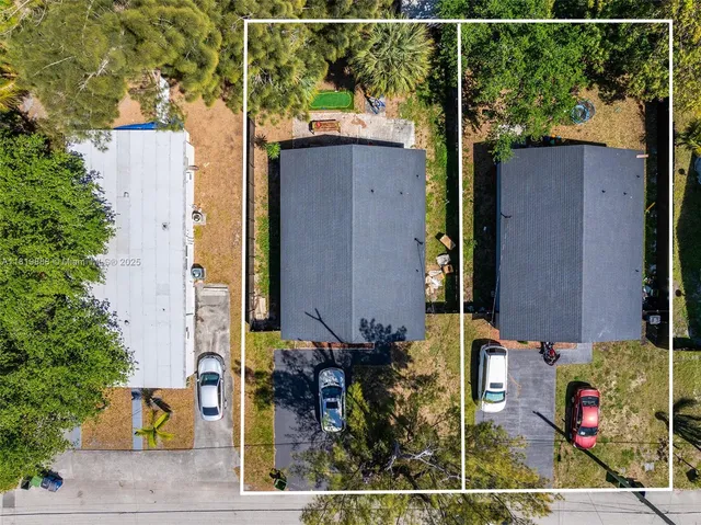 an aerial view of a house with a backyard