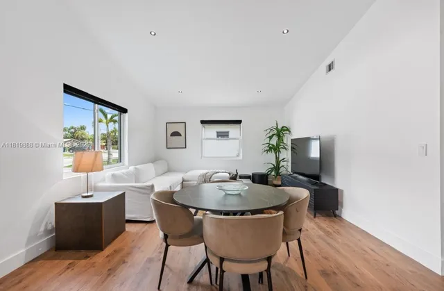 a dining room with furniture and wooden floor