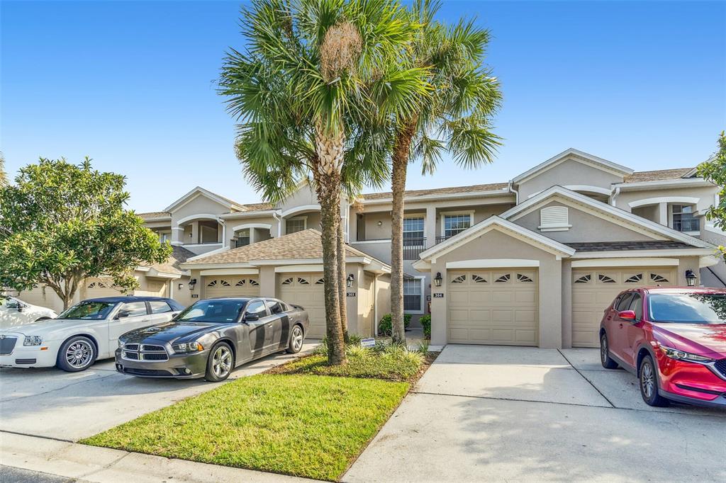 a front view of a house with a garden and parking space