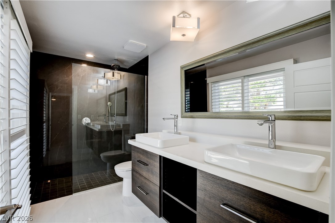 4207 Ridgecrest Drive Las Vegas, NV 89121 - Photo 16 of 27 Upgraded bathroom featuring double vanity, a stall shower, and slider doors to pool backyard!!