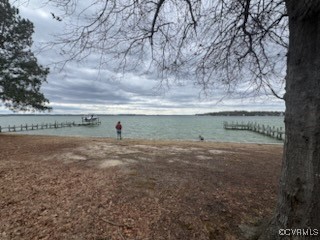791 Stove Point Road Deltaville, VA 23043 - Photo 3 of 4 a view of a field with a tree in the background