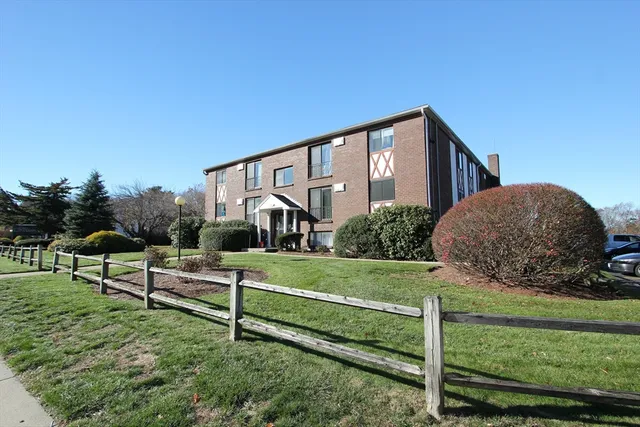 a view of a house with a yard and a garden