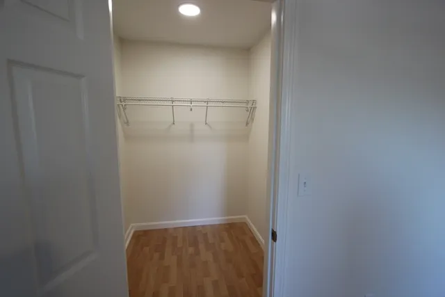 a view of walk in closet with clothes