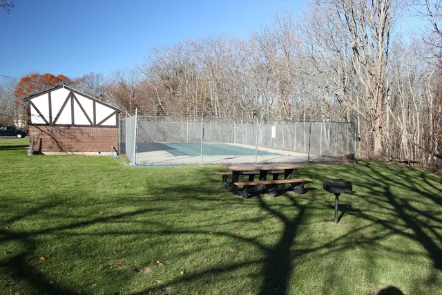 a backyard of a house with table and chairs