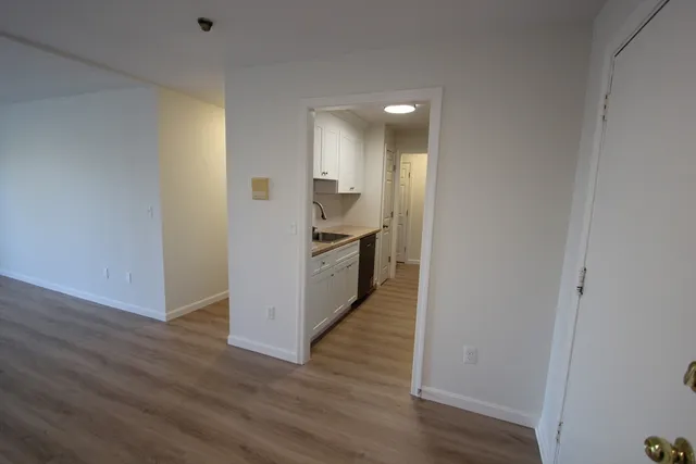a view of a kitchen cabinets and wooden floor