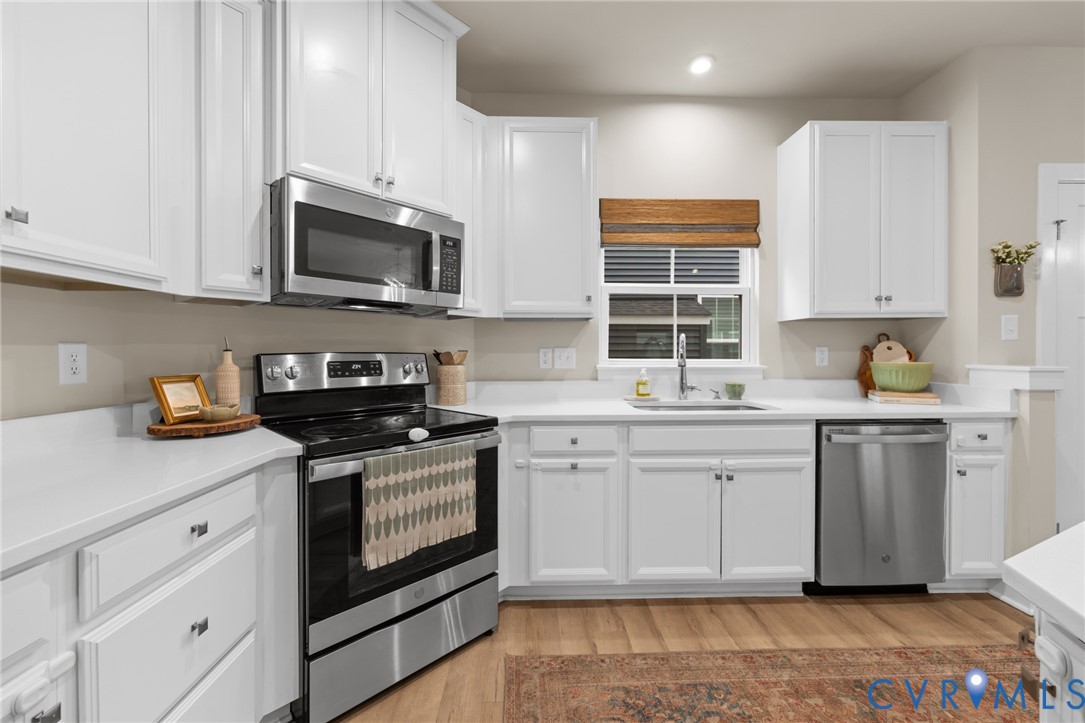6504 Kinns Road Richmond, VA 23225 - Photo 11 of 34 Modern kitchen featuring white cabinetry, stainles