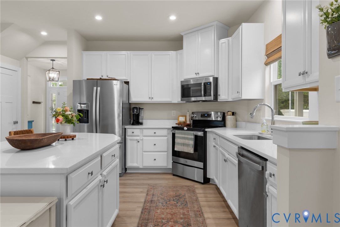 6504 Kinns Road Richmond, VA 23225 - Photo 13 of 34 Kitchen featuring white cabinetry, light counterto