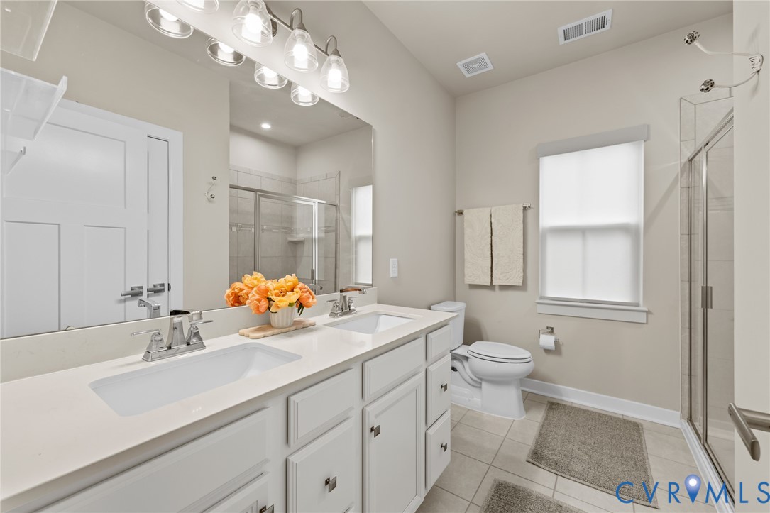 6504 Kinns Road Richmond, VA 23225 - Photo 19 of 34 Bathroom featuring a dual vanity with white cabine