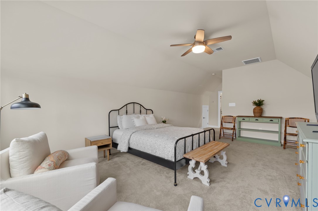 6504 Kinns Road Richmond, VA 23225 - Photo 21 of 34 Carpeted room with a vaulted ceiling, illuminated
