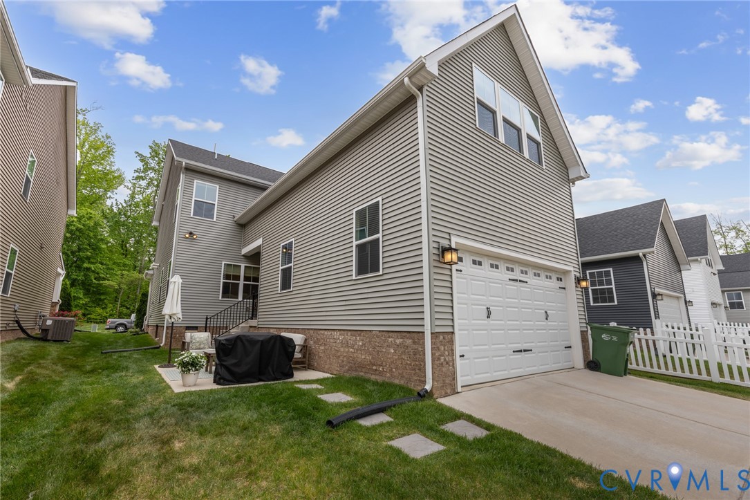 6504 Kinns Road Richmond, VA 23225 - Photo 29 of 34 Gray horizontal siding exterior with a two-car gar