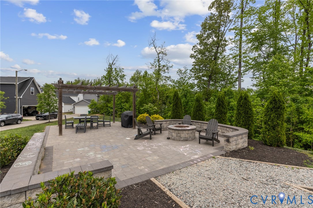 6504 Kinns Road Richmond, VA 23225 - Photo 32 of 34 Expansive paver patio featuring a built-in stone f