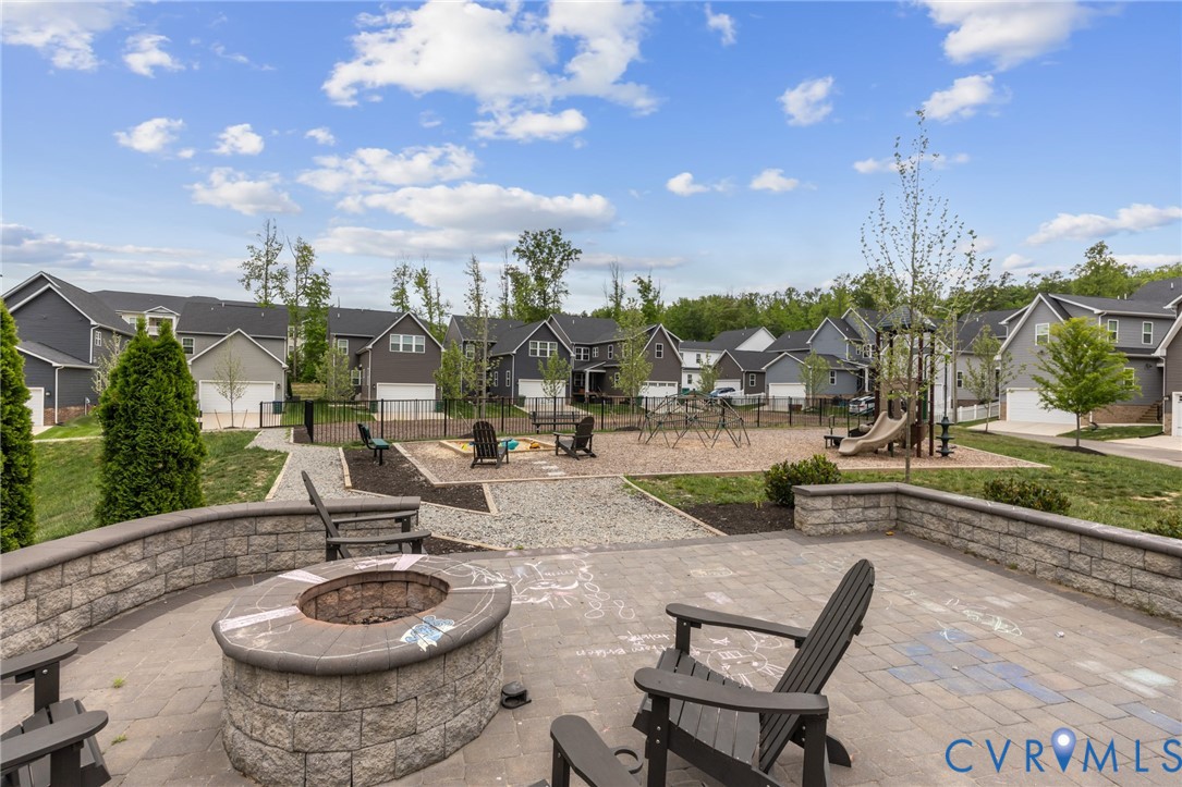 6504 Kinns Road Richmond, VA 23225 - Photo 33 of 34 Spacious paver patio featuring a built-in stone fi