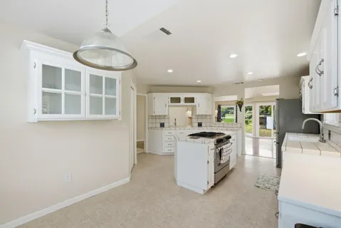 a kitchen with a sink stove and refrigerator
