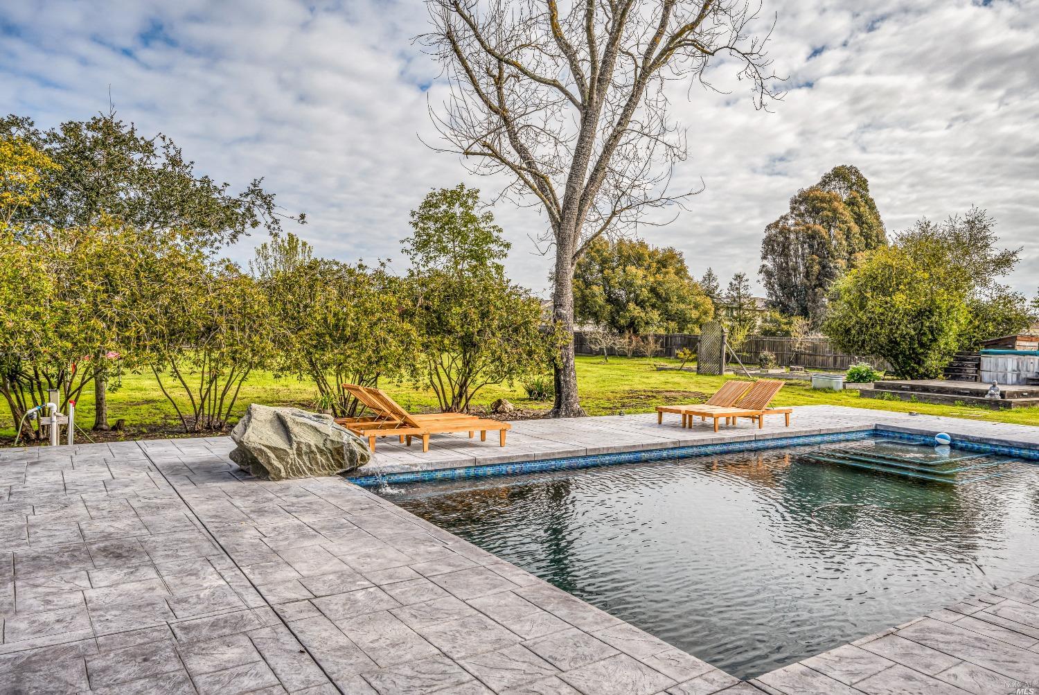 a view of swimming pool with a patio