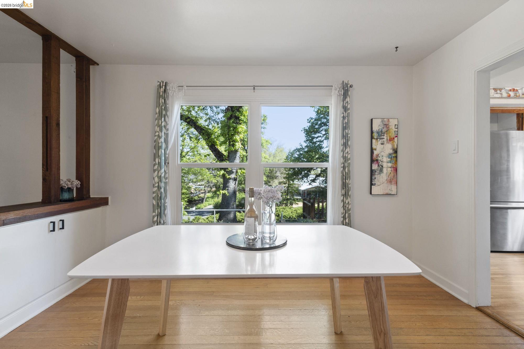 18363 Yosemite Road Tuolumne, CA 95379 - Photo 5 of 34 Dining area featuring light wood-finish flooring and a large window overlooking mature trees