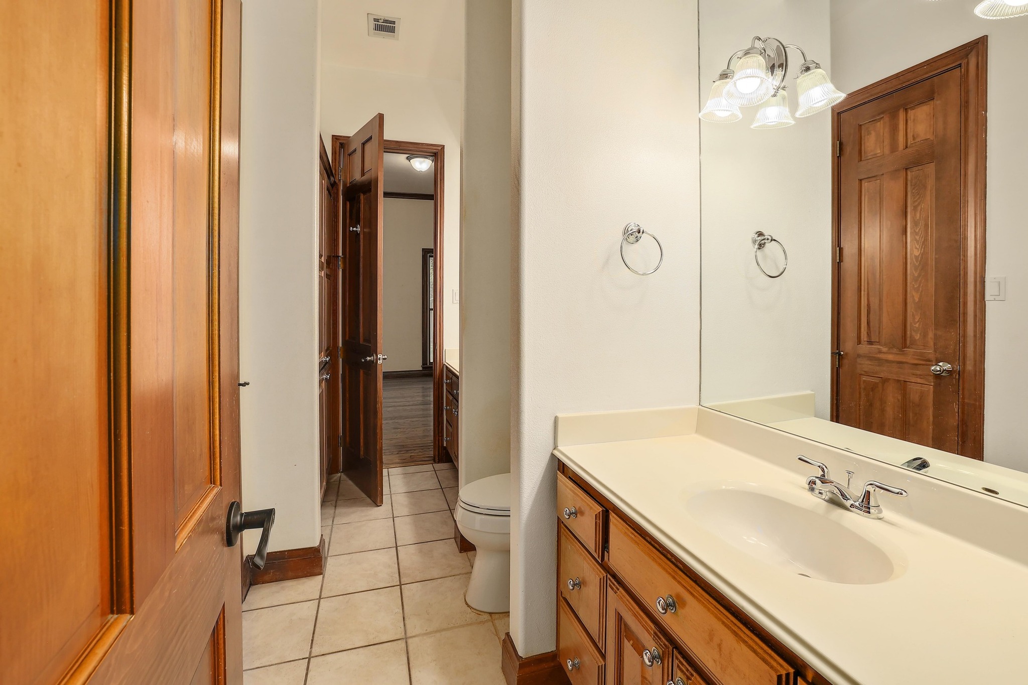 3900 Shell Road Georgetown, TX 78628 - Photo 23 of 40 Half bathroom featuring vanity, light tile patterned flooring, and a chandelier