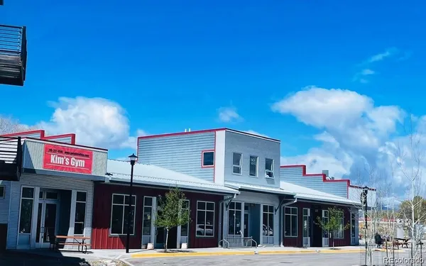 a view of a cafe with a table and chairs in front of building
