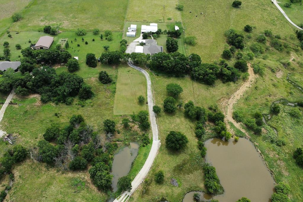 3007 McReynolds Road Sanger, TX 76266 - Photo 35 of 39 Expansive rural landscape featuring a winding paved road, multiple ponds, mature trees, and open green spaces