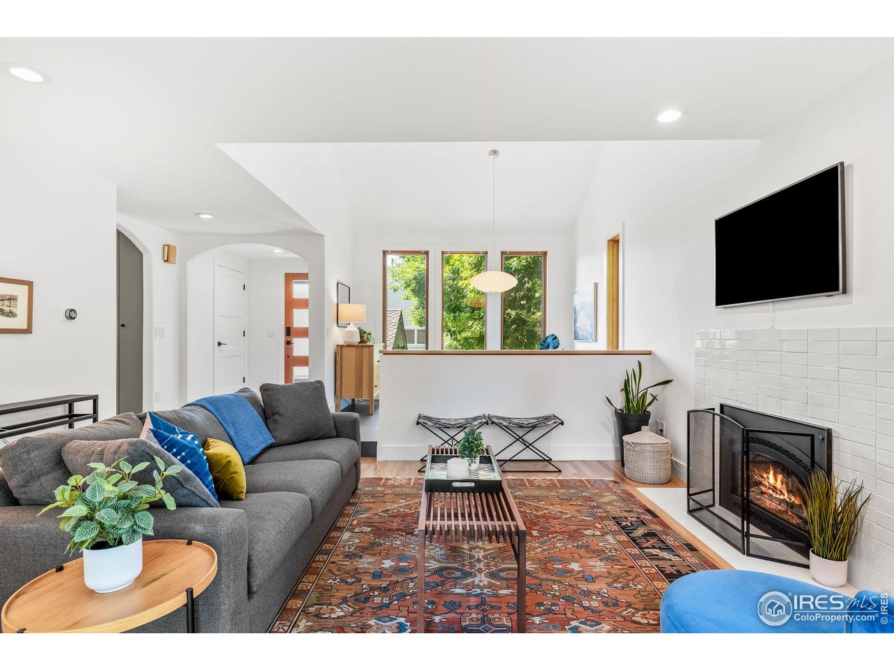 3675 Roundtree Court Boulder, CO 80304 - Photo 2 of 40 Cozy living room with fireplace creates a welcoming environment.