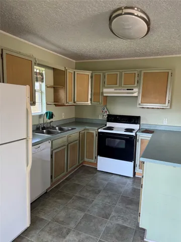 a kitchen with cabinets and stainless steel appliances