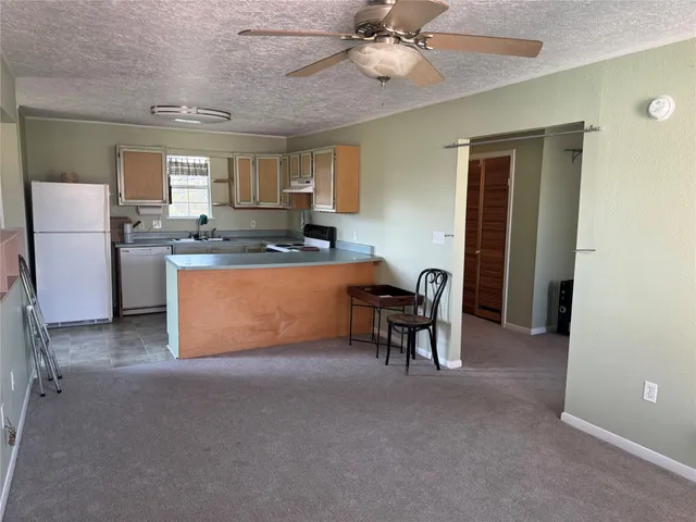 a living room with furniture and a dining table