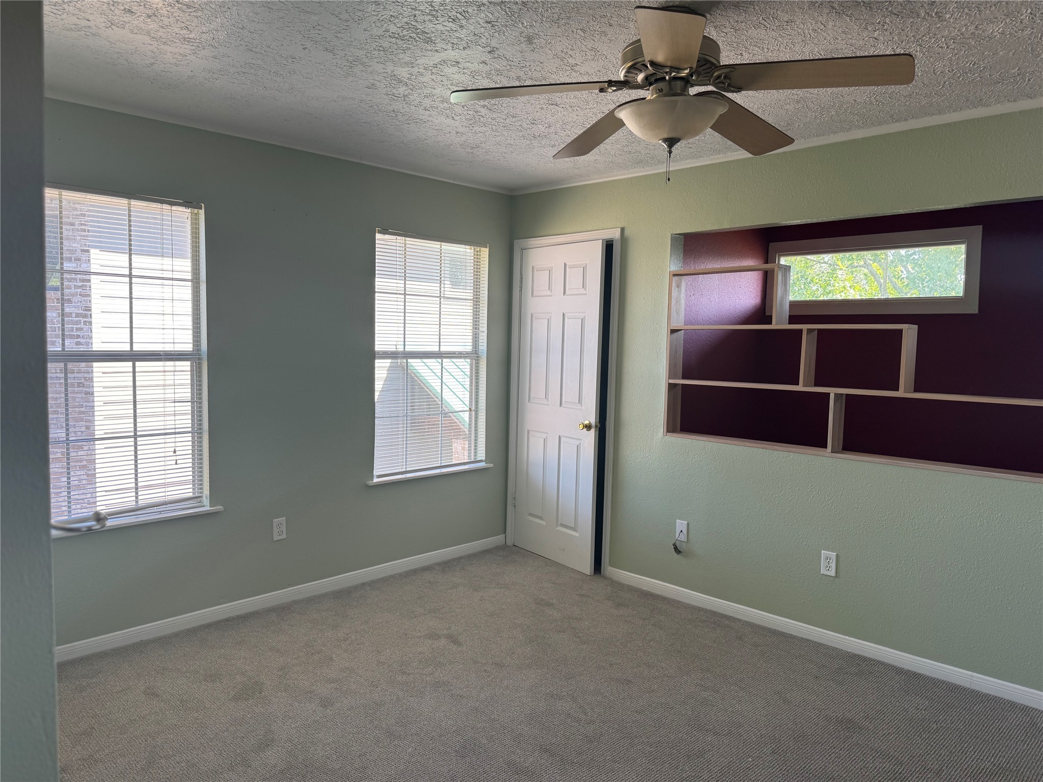 3934 Fernwood Drive, Unit A Houston, TX 77021 - Photo 4 of 10 an empty room with windows and fan