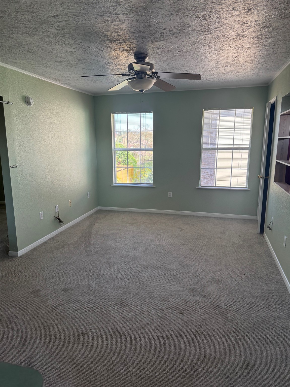 3934 Fernwood Drive, Unit A Houston, TX 77021 - Photo 8 of 10 an empty room with a windows and ceiling fan